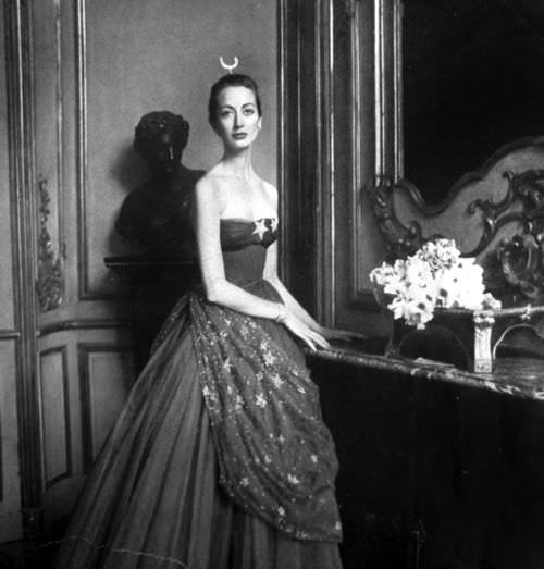 Model wearing a gown by Pierre Balmain for Vogue Paris, 1951